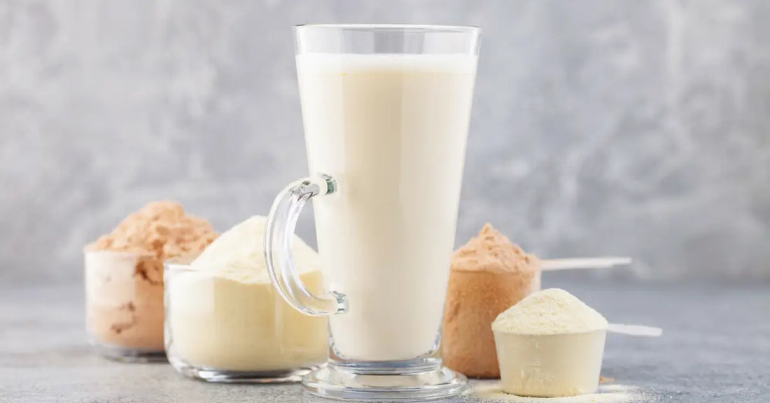 Assorted scoops of different types of vegan protein powder with a glass of shake.