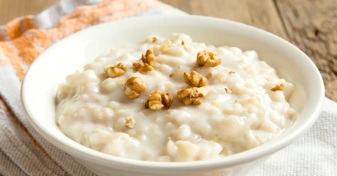 Bowl of oatmeal topped with walnuts, illustrating the addition of protein powder to oatmeal.